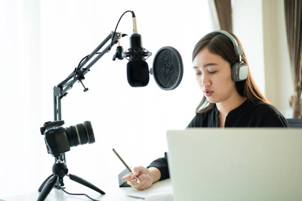 istock Asian young woman podcasting at home 1302291249