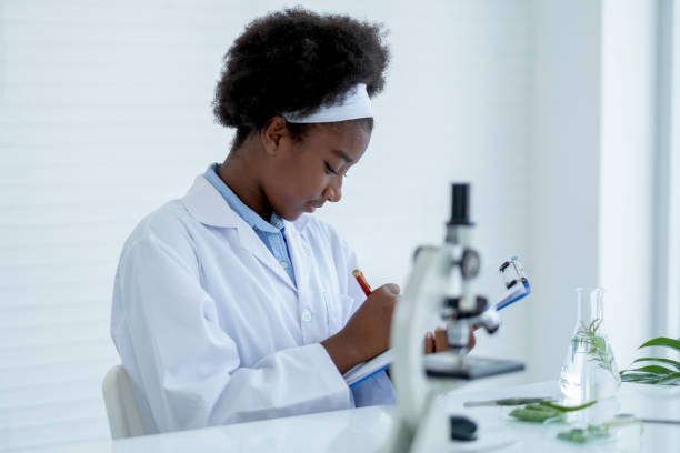 istock Young African American Scientist record analysis data and sit in room with other tools in laboratory and experiment 1302291286