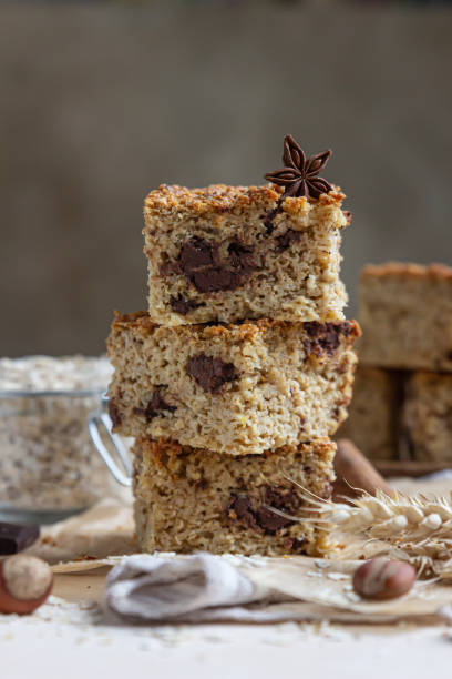 istock Oatmeal squares with chocolate, light concrete background. Diet bars. Healthy bakery for breakfast or dessert. 1302292771