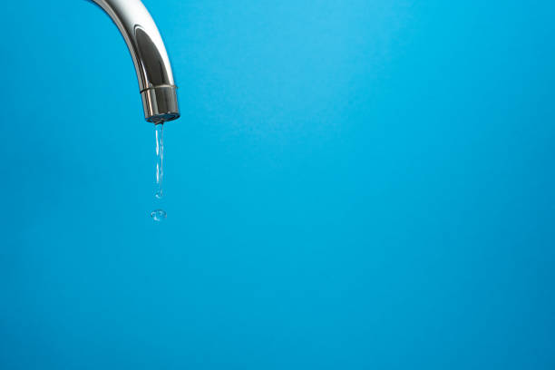 istock water coming out of a tap on blue background 1302293708