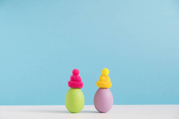 istock Easter holiday concept with cute eggs with funny faces. Different emotions and feelings. Lovely couple in hats 1302299057