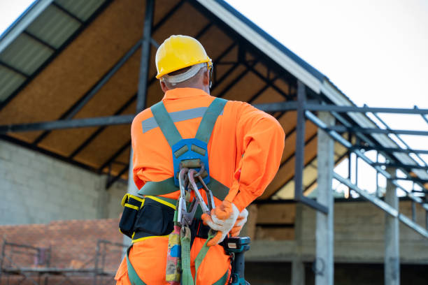 Electrical engineers wearing safety harness and safety line. Electrical engineers wearing safety harness and safety line standing at construction site. safety harness stock pictures, royalty-free photos & images
