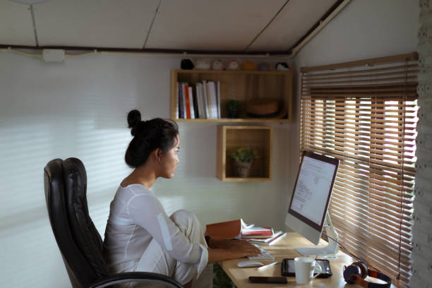 istock Asian woman She works at home She is analyzing the work 1302299564