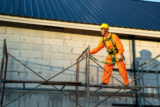 Construction worker wearing safety harness belt during working at high place.