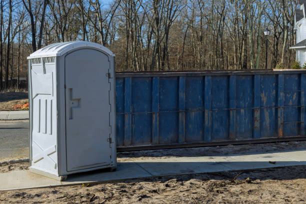 istock Portable restroom on house under construction in a dumpsters construction with garbage new house 1302300585