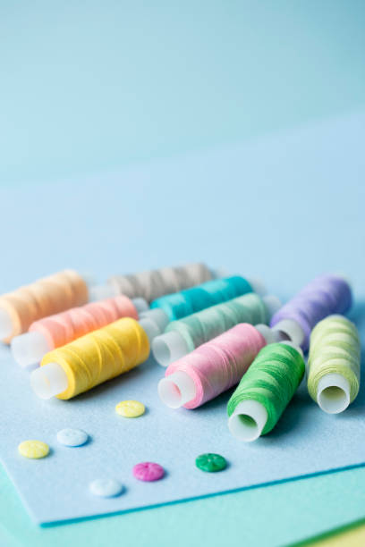 istock Reels of thread with buttons on felt close-up 1302302700