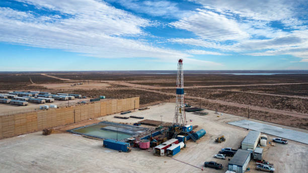 Drone View Of An Oil Or Gas Drill Fracking Rig Pad with Beautiful Cloud Filled Sky Drone View Of An Oil Or Gas Drill Fracking Rig Pad with Beautiful Cloud Filled Sky oil pump oil industry alberta equipment stock pictures, royalty-free photos & images