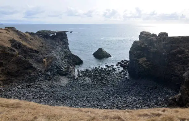 Stunning black stone beach on the rugged coastline of Iceland.