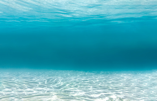 Seabed and water surface on clear turquoise water