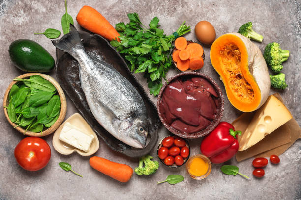 healthy balanced food background. foods rich in vitamin a. turkey liver, vegetables, fresh fish, butter and cheese. top view, flat lay. - carotene imagens e fotografias de stock