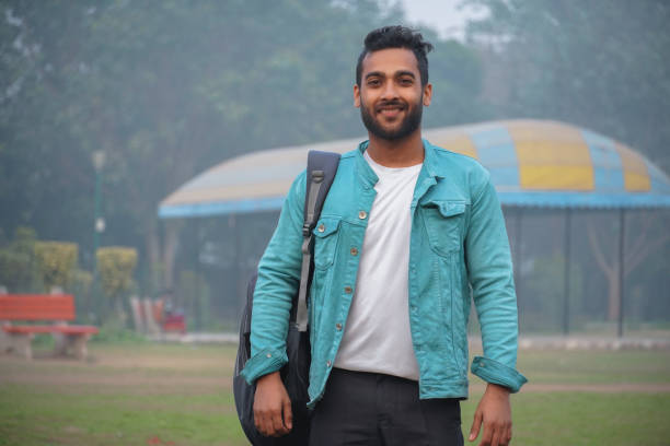 istock happy young student at collage campus first time standing at park 1302305491