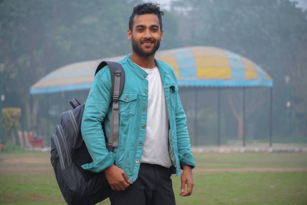 istock happy young student at collage campus first time standing at park 1302305515