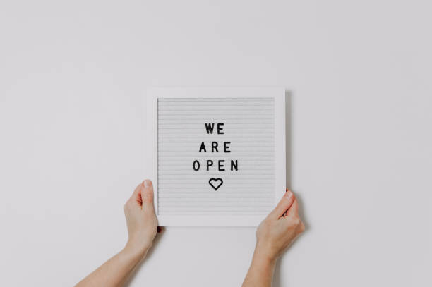 We are open sign for small businesses. Hands holding a white letter board with words. We are open sign for small businesses. Hands holding a white letter board with words. Store reopening, end of lockdown. reopening photos stock pictures, royalty-free photos & images