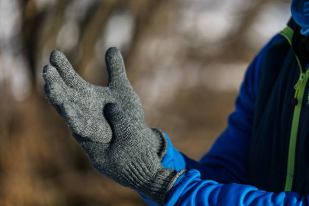 istock Young man putting on winter gloves 1302307481