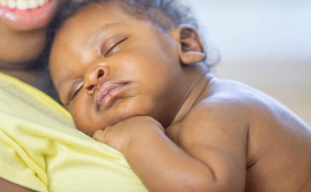 istock Newborn baby sleeping on mother's chest 1302307587