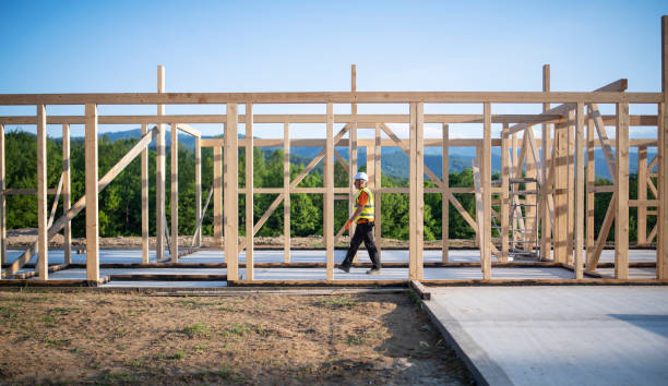 istock Senior builder working on a wooden house. 1302307626
