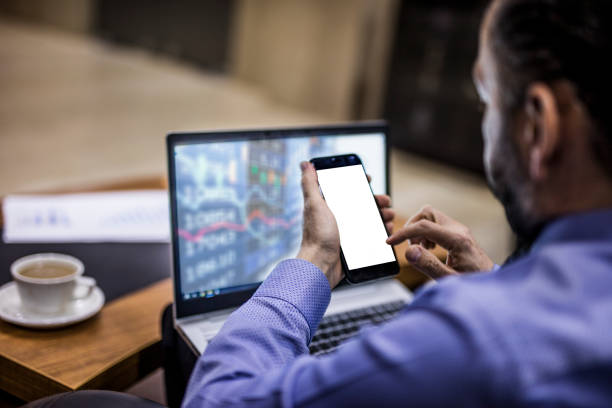 istock Businessman using smartphone with blank screen in his office 1302309357