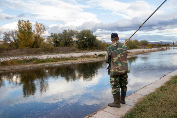istock Senior man fishing on the river 1302310493