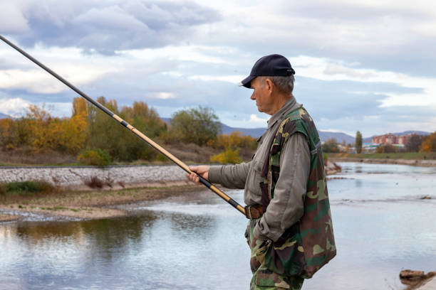 istock Senior man enjoying fishing alone 1302310559