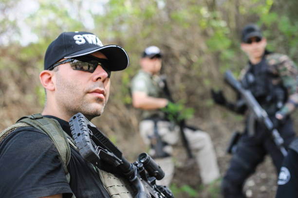 istock Army soldiers in action tactical combat shooting from machine gun 1302311819