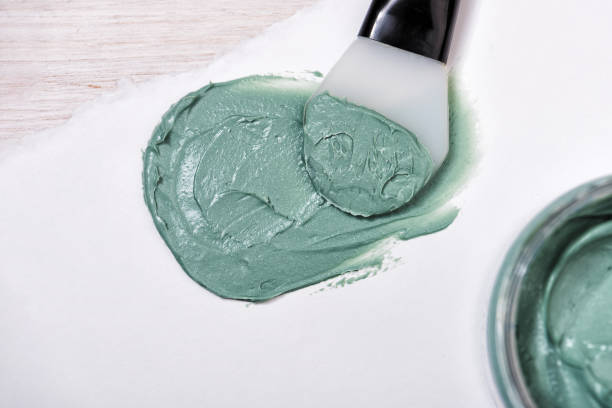 istock Natural spirulina face clay mask on paper background 1302312091