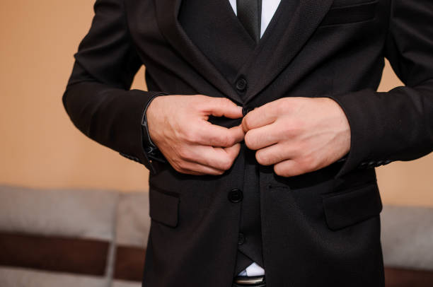 istock The groom buttons his jacket 1302312211