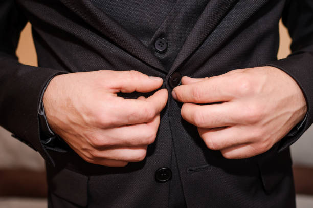 istock The groom buttons his jacket 1302312222
