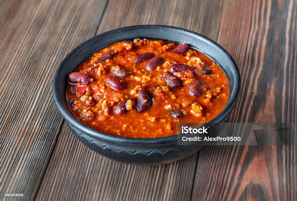 Bowl of chili con carne Bowl of chili con carne on a wooden table Chili Con Carne Stock Photo