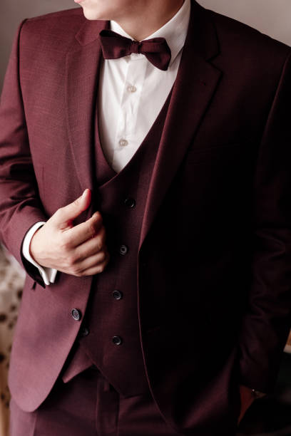 istock man in an elegant brown tuxedo with a silk bow tie and a watch. selective focus. 1302314403