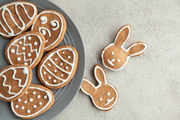 istock Easter cookies on a grey plate on a stone background. Easter bunnies. Copy space and top view. 1302314607