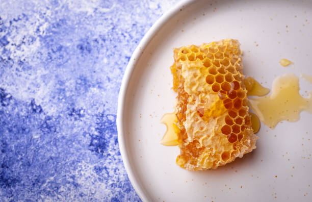 istock Honeycomb in plate on blue background 1302314832