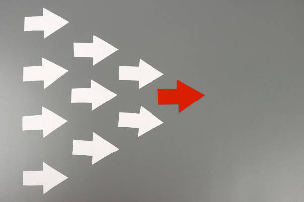 istock Red arrow leads many white arrows, a leadership concept 1302316300