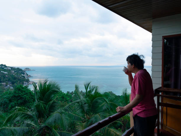 istock man drinking morning coffee at sea view terrace 1302318183