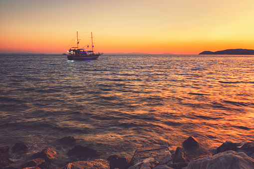 Cruise boat on beautiful sunset at Greek island