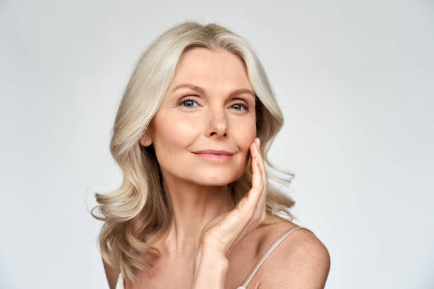 beautiful gorgeous 50s mid aged mature woman looking at camera isolated on white. mature old lady close up portrait. healthy face skin care beauty, middle age skincare cosmetics, cosmetology concept - tratamento de pele imagens e fotografias de stock