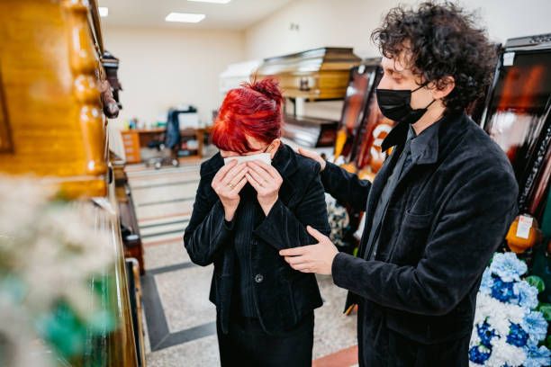 son comfort his mother in funeral parlor - funeral family sadness depression imagens e fotografias de stock