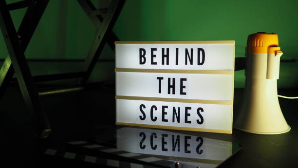 istock Behind the scenes letterboard text on Lightbox or Cinema Light box. Movie clapperboard megaphone and director chair beside. Background LED color change. static camera in video production studio. 1302321040