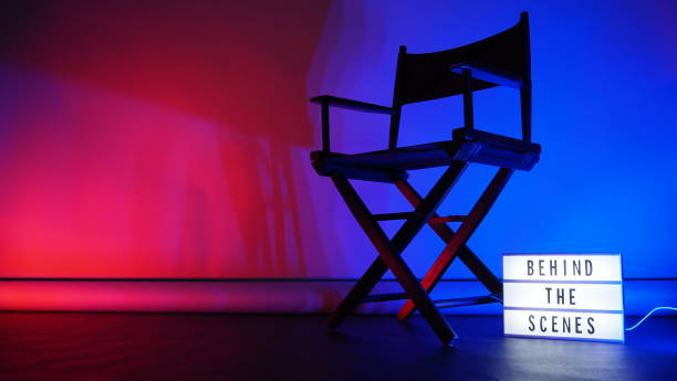 istock Behind the scenes letterboard text on Lightbox or Cinema Light box. Movie clapperboard megaphone and director chair beside. Background LED color change. static camera in video production studio. 1302321043