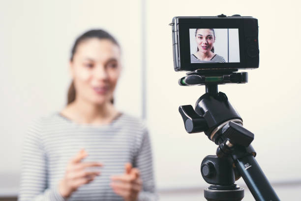 istock Young female blogger on camera screen 1302322327