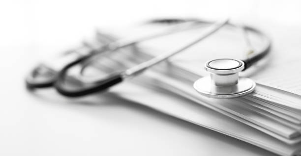 istock Stack of report medical documents and stethoscope isolated on white background 1302323036