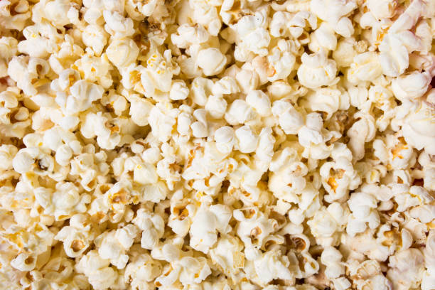 istock popcorn flakes close-up. Harmful fast food 1302324899