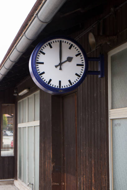 istock Big clock hanging over the platform of a train station 1302325872