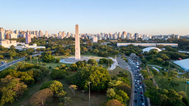 Sao Paulo city,  obelisk monument and Ibirapuera Park. Aerial view of Sao Paulo city and obelisk monument, next to Ibirapuera Park. Prevervetion area with trees and green area of Ibirapuera park  in Sao Paulo city,  Brazil. são paulo state stock pictures, royalty-free photos & images