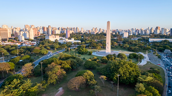 Aerial view of Sao Paulo city and obelisk monument, next to Ibirapuera Park. Prevervetion area with trees and green area of Ibirapuera park  in Sao Paulo city,  Brazil.