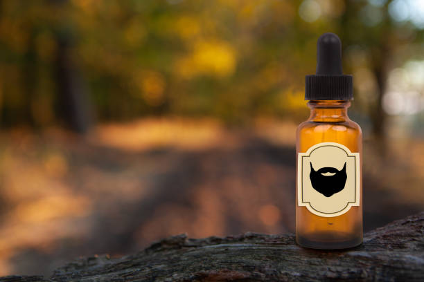 istock Beard Balm Or Oil on a blurry forest background. Copy space for text, 1302331022