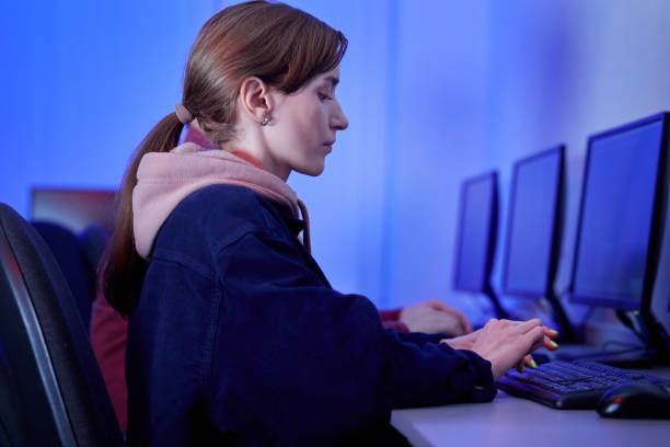 istock A young woman is working in an office at a computer and typing on a keyboard. 1302331904