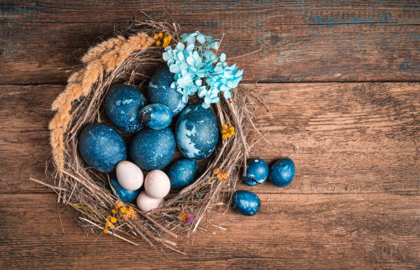 istock Easter background with quail and chicken blue eggs on wooden background 1302332106
