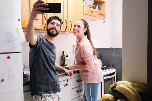 istock Couple taking a photo in the kitchen during joyful moment 1302332206