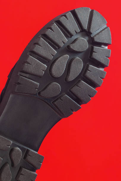 istock Black shoe sole close-up on red background 1302334625