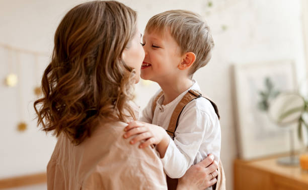 istock Happy woman and boy  touching noses 1302335278